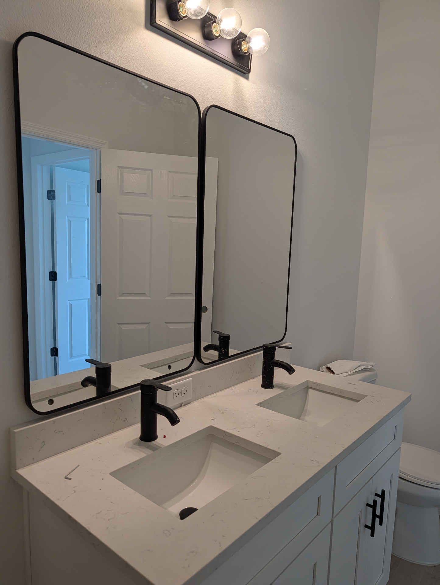 Tampa bathroom double vanity with quartz counter, black fixtures and rectangular mirrors