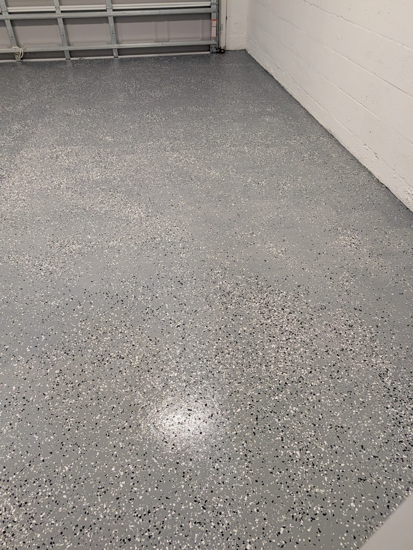 Gray epoxy flake garage floor coating installed on a Tampa home